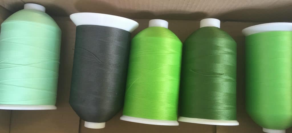 green sewing machine thread reels