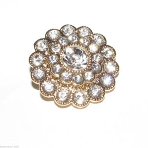 gold flower button with multiple white dimantes