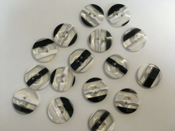 clear plastic buttons with white and black stripes